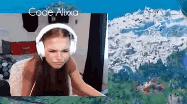 a woman wearing headphones is sitting in front of a computer monitor .