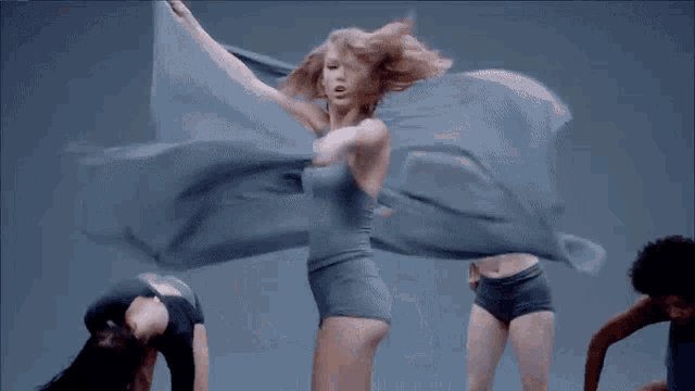 a group of female dancers are dancing in a line