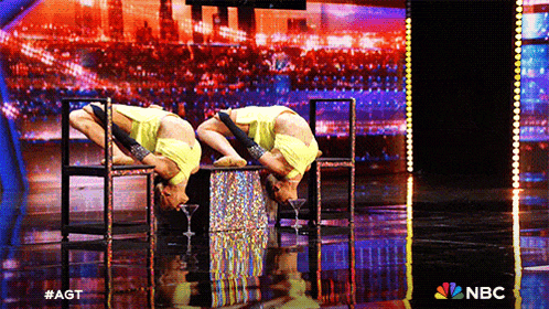 a nbc ad shows two women performing a trick on a stage