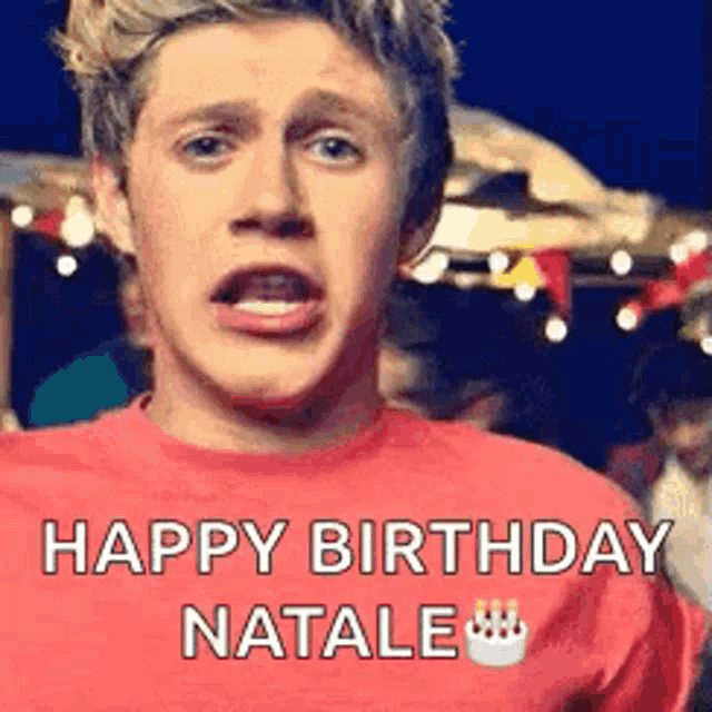 niall horan is wearing a red shirt and making a funny face .