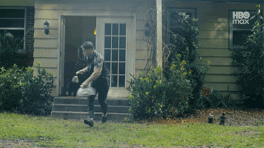 a man walking in front of a house with hbo max written on the bottom of the screen