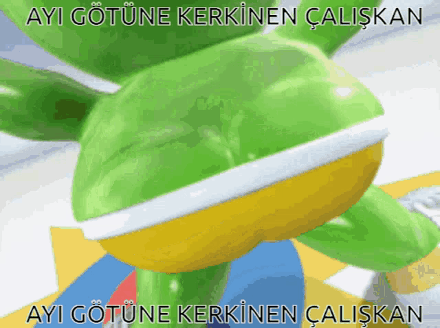 a green and yellow gummy bear with the words ayi gotune kerkinen caliskan on the bottom