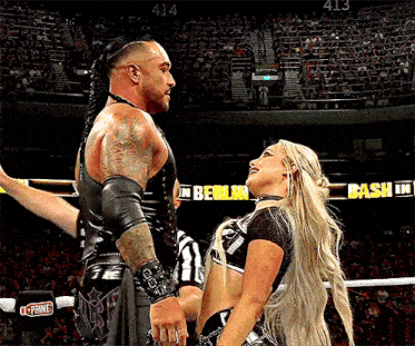 a man and a woman in a wrestling ring with a sign that says berlin bash in