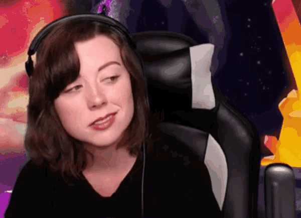 a woman wearing headphones sits in a chair