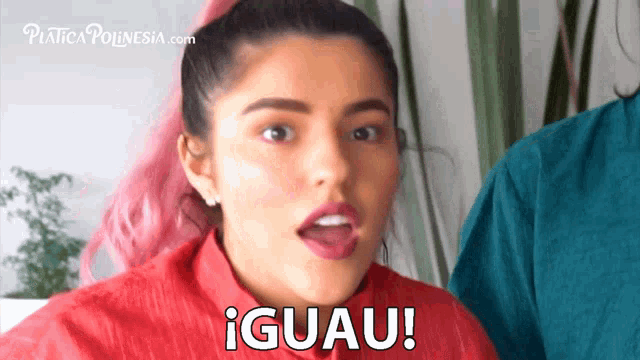 a woman with pink hair is making a funny face and the words iguau are on her face