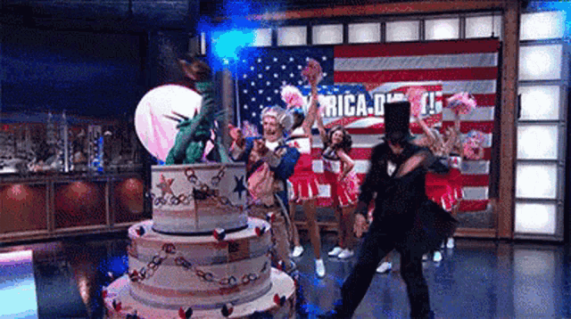 a group of people are dancing in front of an american flag with the word america on it