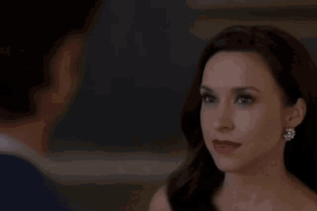a woman with red lipstick is looking at a man