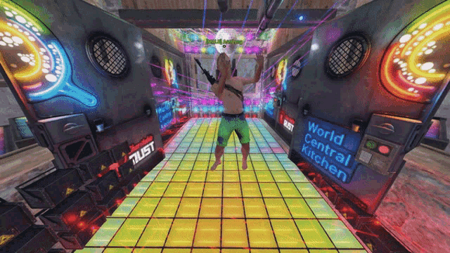 a man standing on a dance floor with a sign that says world central kitchen on it