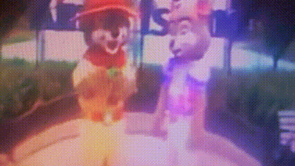 a couple of cartoon characters are standing next to each other on a stage .