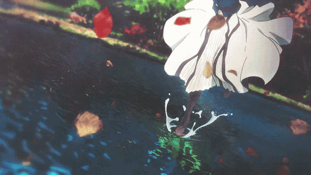 a woman in a white dress is jumping into a body of water