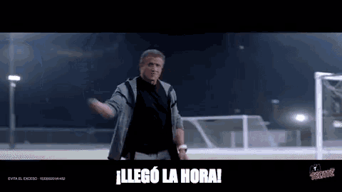 a man is standing in front of a soccer goal with the words " llego la hora " written on the bottom