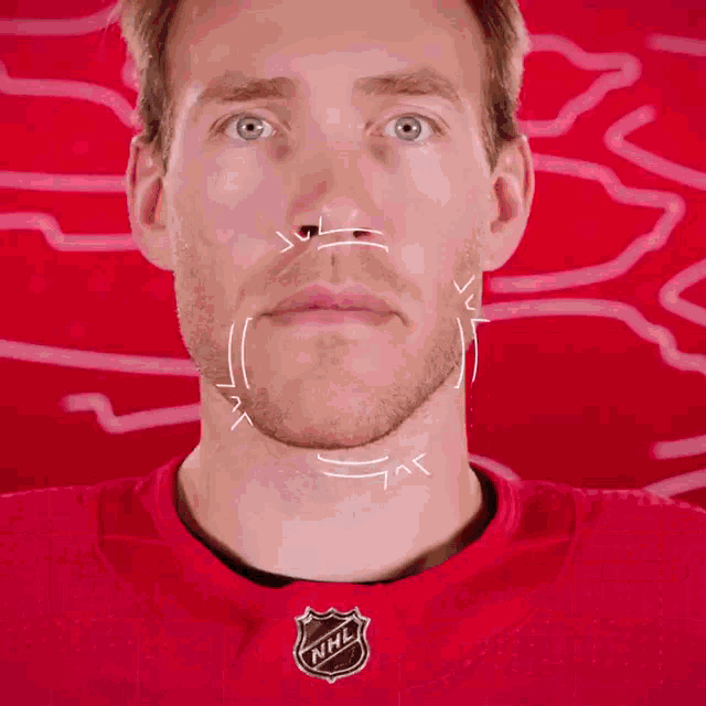 a man wearing a red nhl jersey is shown