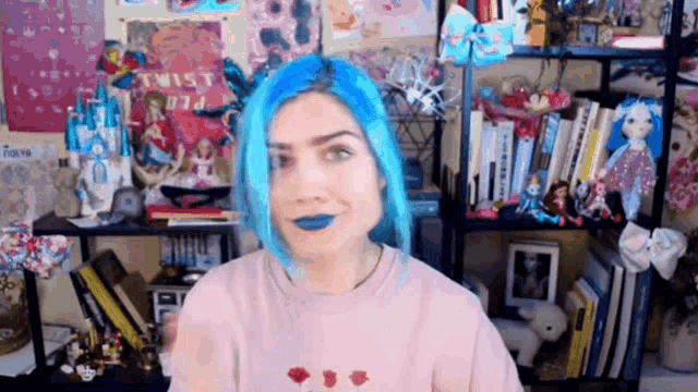 a girl with blue hair is standing in front of a bookshelf with a sign that says twist
