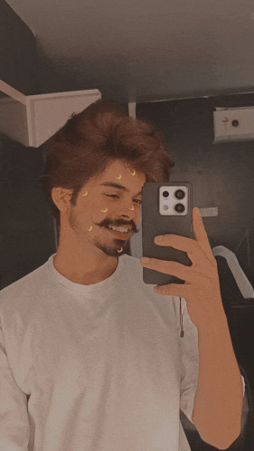 a man taking a picture of himself with a phone