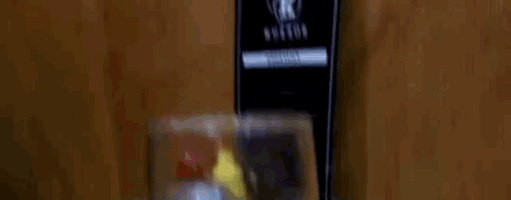 a glass of orange juice is being poured into a pitcher on a table .