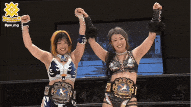 two female wrestlers are posing for a picture with their arms in the air with the hashtag #pw_mg