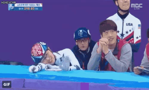 a group of people are watching a race and one of them is wearing a usa shirt