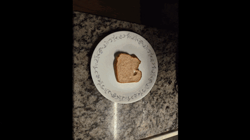 a bottle of peanut butter sits next to a plate of toast and a knife