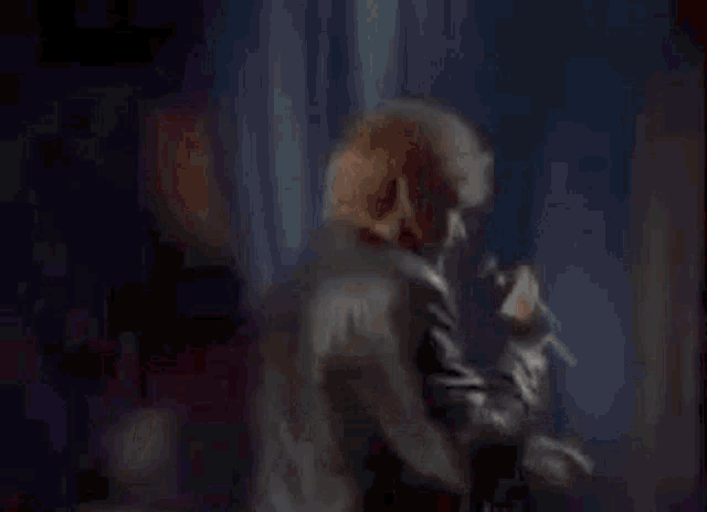 a man is singing into a microphone and saying `` we love you ! ''