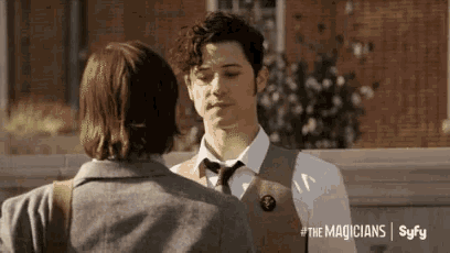 a man in a vest and tie is talking to another man with the magicians syfy written on the bottom