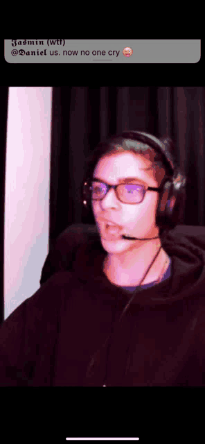 a young man wearing headphones and glasses says " now no one cry " in a text message