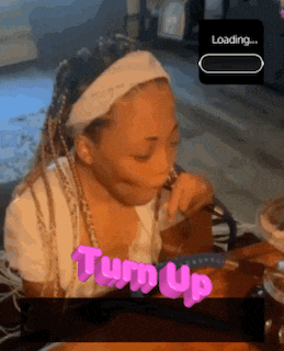 a girl sitting at a table with the words turn up written in pink letters