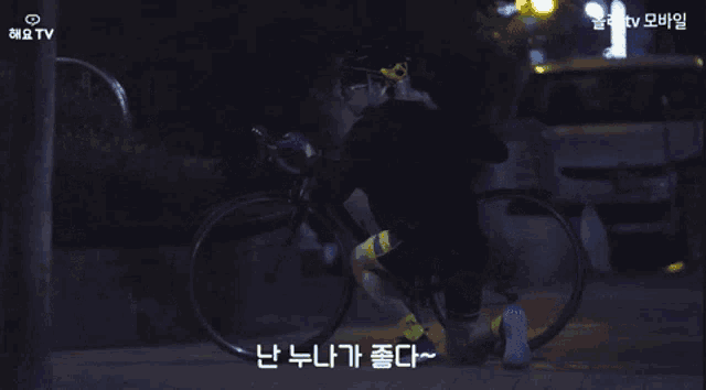 a person riding a bike with a tv logo on the bottom right