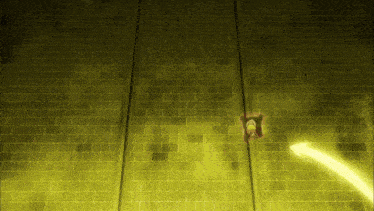 a yellow brick wall with a person standing in the middle of it