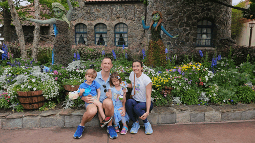 a family posing for a picture in front of a building