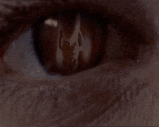 a close up of a woman 's face with dark eyes