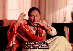a woman sitting on a couch with a red scarf around her neck and the words keede padein dur fitte moonh above her