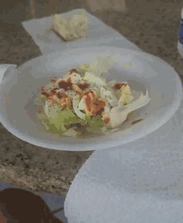 a plate of food with lettuce and eggs on a table