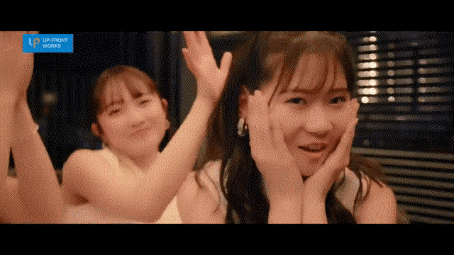 two girls are dancing in front of a sign that says " up right works "