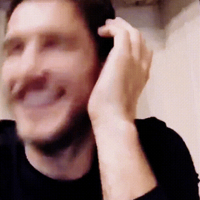 a blurry picture of a man talking on a cell phone