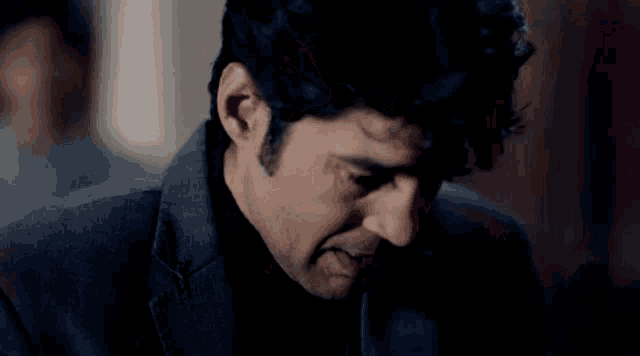 a close up of a man 's face with a serious expression .