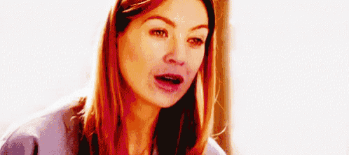 a woman with long hair is making a funny face .