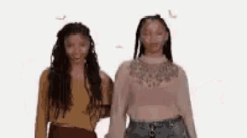 two women are standing next to each other on a white background and smiling .