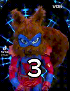 a squirrel is wearing a superhero costume and holding a number three .