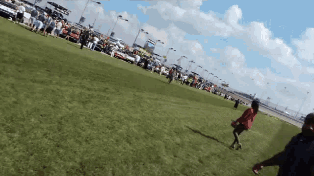 a woman in a red dress is running in a field