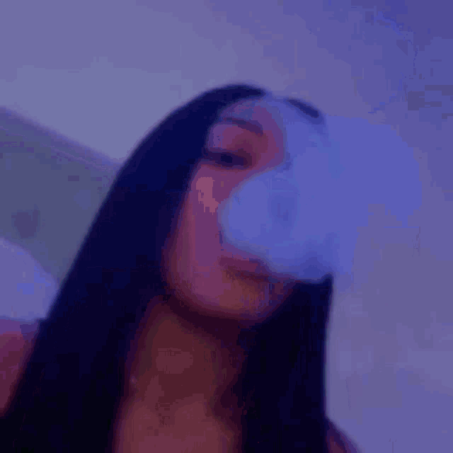 a blurry picture of a woman smoking a cigarette with the word glitch behind her