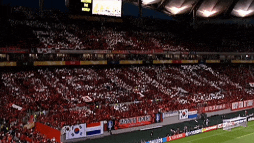 a crowd of people in a stadium with a banner that says philips