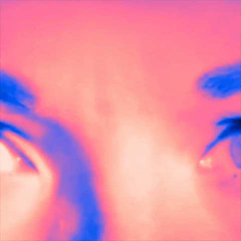 a close up of a woman 's face with a surprised expression