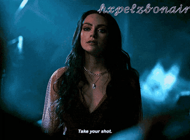 a woman in a red dress says take your shot in a dark room