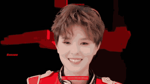 a boy in a red uniform is smiling in front of the word ck gi