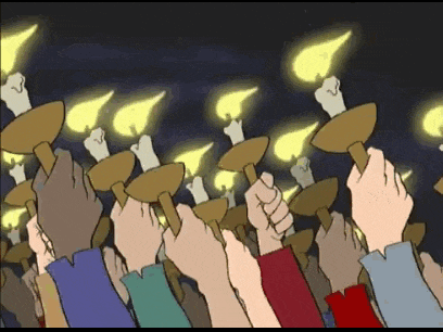 a crowd of people holding up candles in their hands
