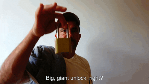 a man holding a padlock with the words big giant unlock right below