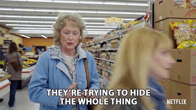 a woman in a blue jacket says they 're trying to hide the whole thing in a grocery store