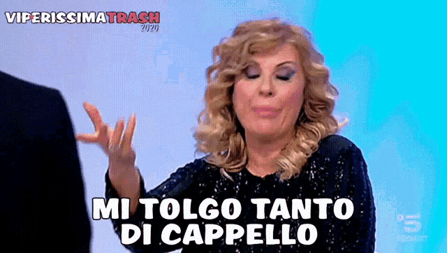 a woman says " mi tolgo tanto di cappello " while making a funny face