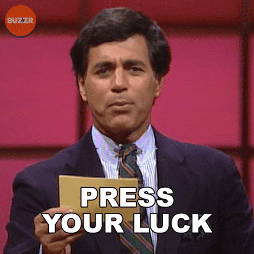 a man in a suit and tie holds a card that says press your luck