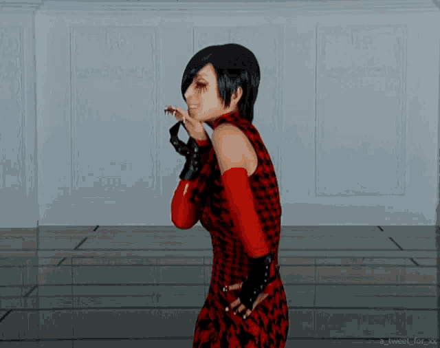 a woman in a red and black dress is standing in front of a white wall with a tweet for xx below her